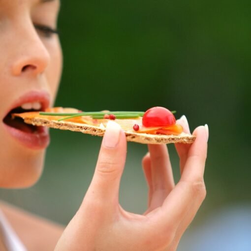 Woman eating healthy cracker snack