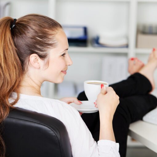 Woman taking a coffee break in her office